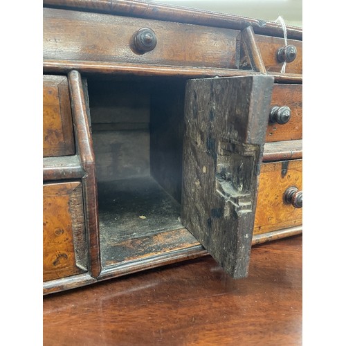 1244 - 18th century burr walnut and cross banded table-top stationary chest, the slope front with seven dra... 