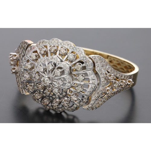 56 - Large impressive 14ct diamond set hinged bangle, with an oval lobed pieced centre cluster set with r... 