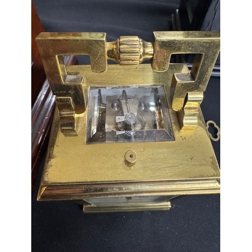 1205 - Repeater carriage clock with alarm and striking on a gong, within a pillared gorge style brass case,... 