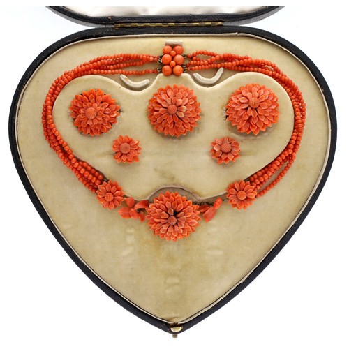 Fine carved coral jewellery suite, comprising a necklace with a yellow metal clasp, three brooches and two stick pins