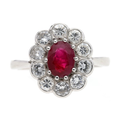 Good platinum ruby and diamond oval cluster ring, the ruby0.80ct approx, in a border of ten round brilliant-cut diamonds, estimated 0.60ct approx, clarity SI, colour G/H, width 14mm, 6.5gm, ring size M
