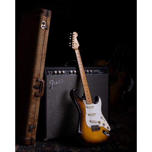 1957 Fender Stratocaster electric guitar, made in USA; Body: Two-tone sunburst finished alder, large buckle patch to back, light checking, smaller blemishes, various lighter scratches and dings; Neck: maple, 8-57 pencil date, minor surface dings; Fretboard: maple, light wear up to 7th fret; Frets: light wear; Electrics: working and appear original; Hardware: very good; Case: original red lined tweed hard case; Weight: 3.31kg; Overall condition: good