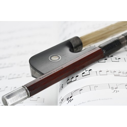 Very fine French silver mounted violoncello bow by and stamped E. Sartory á Paris, the stick round, the ebony frog inlaid with silver rings enclosing pearl eyes and with a silver overlaid ebony adjuster, 76gm