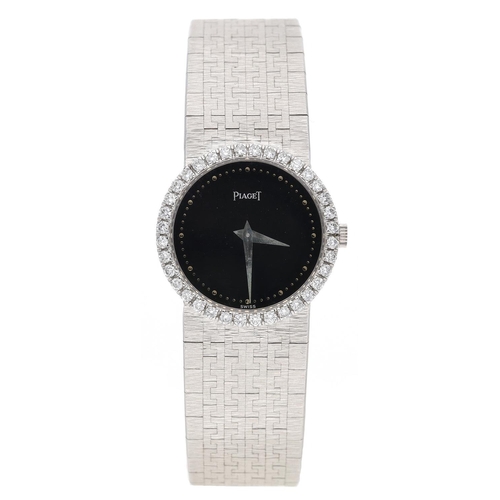 Fine Piaget 18ct white gold lady's dress wristwatch, reference no. 926 A6, case no. 426xxx, circular black dial with dot hour and minute markers, the bezel set with thirty-six round brilliant cut diamonds, integrated Piaget bark finish 18ct white gold bracelet, 69.3gm, 24mm