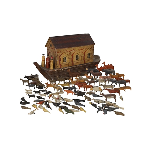 19th century painted wooden Noah's Ark, the roof having a painted dove, the side panel sliding to reveal an open interior to store a range of carved painted animals, 18" long, 10.5" high