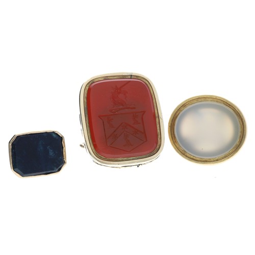 89 - Three assorted gold mounted fobs, one inset with a carnelian intaglio, 19.3gm in total, the largest ... 