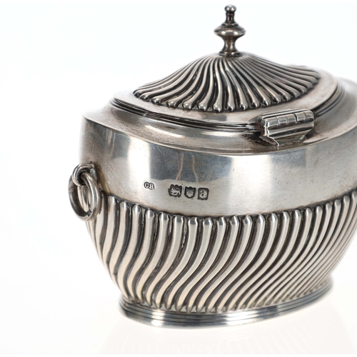 405 - Victorian silver tea caddy, having a gadrooned hinged cover, swing ring handles and a half gadrooned... 
