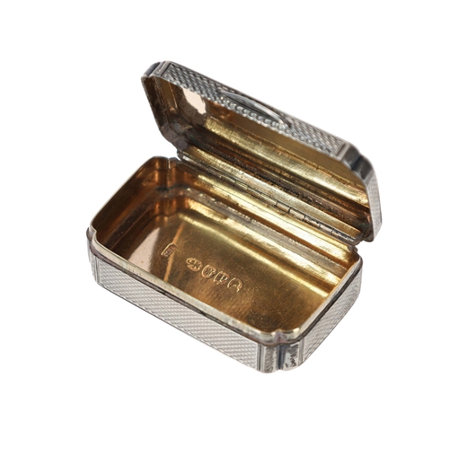 414 - George III engine turned silver snuff box of shaped rectangular form, the hinged cover with small ci... 