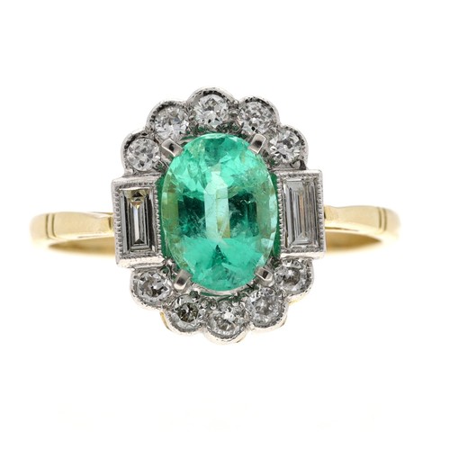 57 - Attractive oval emerald and diamond yellow metal dress ring, the emerald 1.15ct approx, in a white m... 