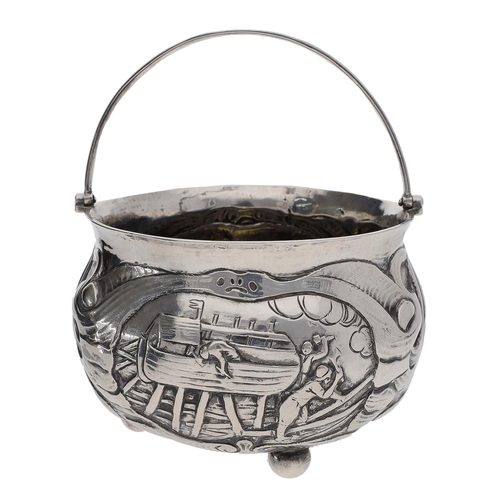 427 - 19th Century continental white metal cauldron, of squat form with swing handle, decorated in relief ... 