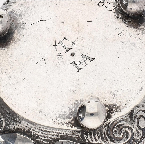 427 - 19th Century continental white metal cauldron, of squat form with swing handle, decorated in relief ... 