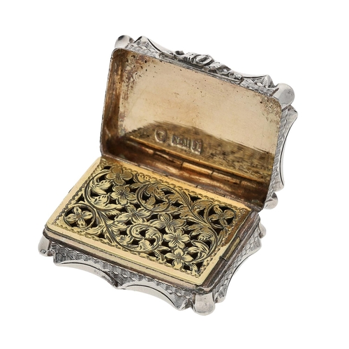484 - Victorian silver vinaigrette, of shaped rectangular outline with engraved decoration around a centra... 