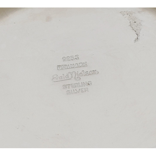 535 - Modern Danish silver candlestick, the support raised on stylised leaf scrolls and a circular stepped... 