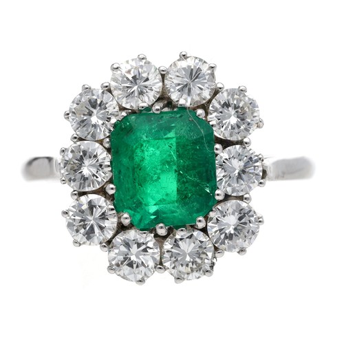 Fine and impressive emerald and diamond white metal cluster ring, the emerald 1.50ct approx, within a setting of ten round brilliant-cut diamonds, 1.30ct approx in total, clarity VS2, colour H-I, 16mm X 14mm, 4.3gm, ring size O/P