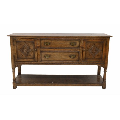830 - 17th century style oak sideboard, the two central drawers flanked by a cupboard to each side, on tur... 