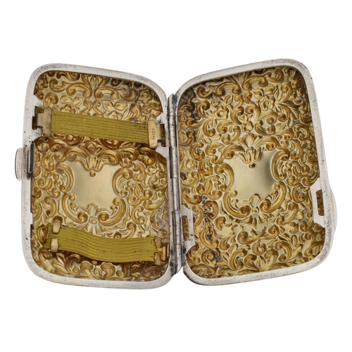 575 - Victorian repoussé silver cigarette case, the cover densely scroll decorated and the interior gilt, ... 