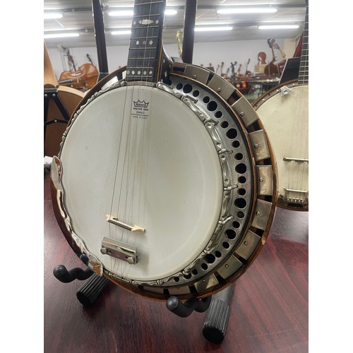 2526 - W.G. Coker & Son four string banjo, with satinwood and ebony banded inlaid concave resonator, mo... 