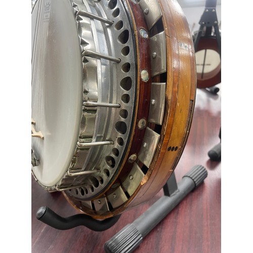 2526 - W.G. Coker & Son four string banjo, with satinwood and ebony banded inlaid concave resonator, mo... 