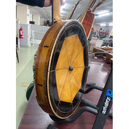 2526 - W.G. Coker & Son four string banjo, with satinwood and ebony banded inlaid concave resonator, mo... 