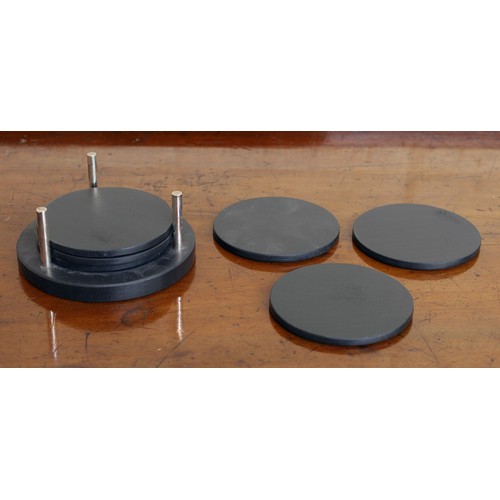 130 - Set of six Cumbrian black slate circular coasters on stand, each coaster 3.75