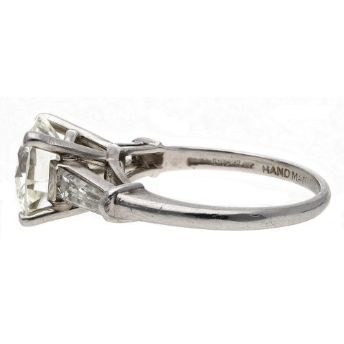 124 - Fine quality platinum large solitaire diamond ring with tapered baguette diamond set shoulders, roun... 