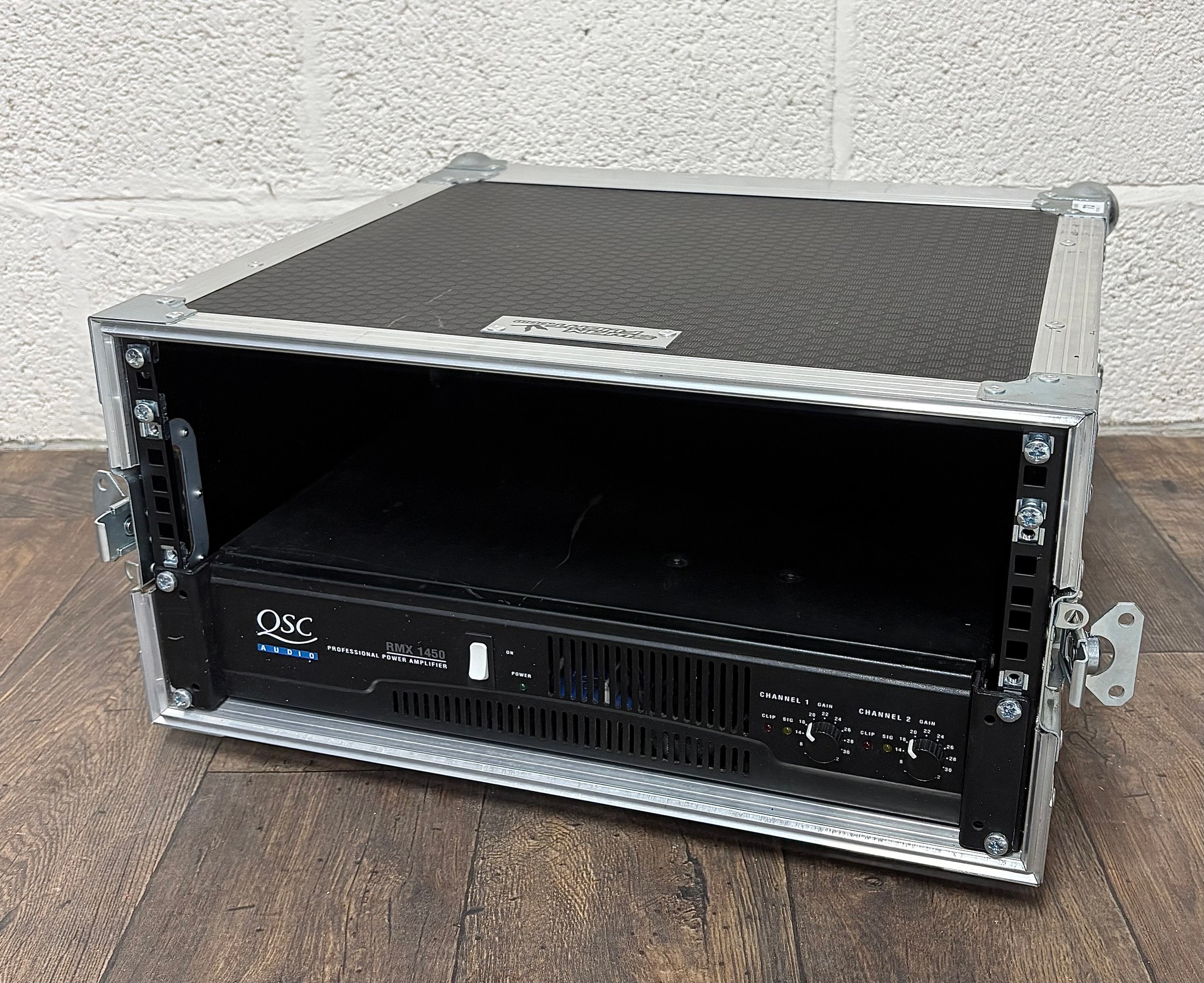QSC Audio RMX-1450 Power Amplifier rack unit, fitted within a ...