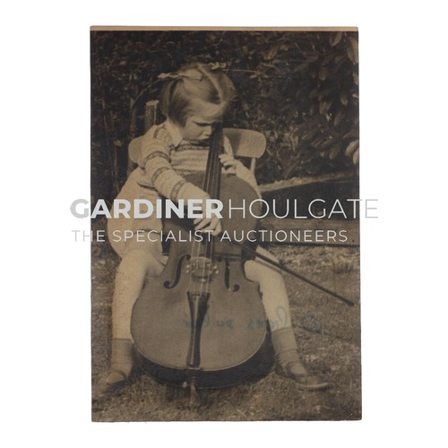 Photograph - A young Jacqueline du Pré playing the cello in a garden (note the concentrating frown), aged 5, 10cm x 14cm; also another similar with duplicate (3)