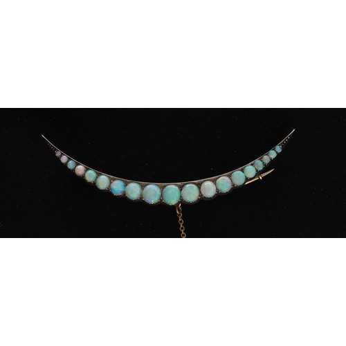 27 - Attractive antique yellow metal opal crescent design brooch, set with nineteen graduated cabouchon o... 