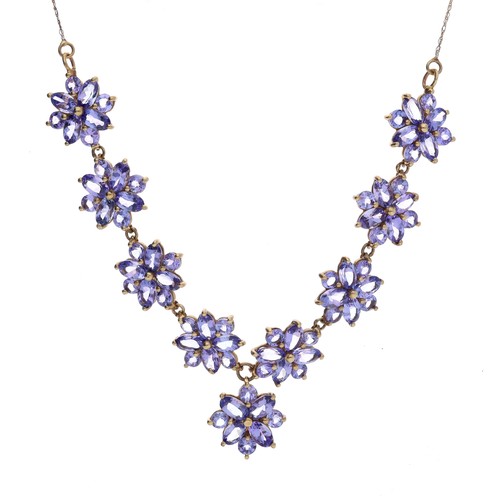 28 - Attractive tanzanite floral cluster 9ct necklace, consisting of nine floral clusters set with marqui... 