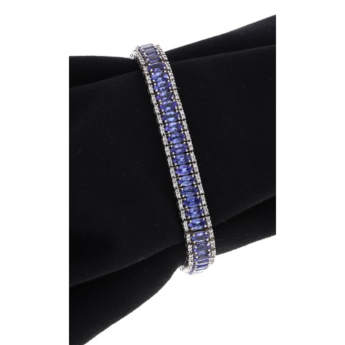 29 - Iliana 18ct white gold tanzanite and diamond bracelet, with a centre band of oval tanzanite within r... 