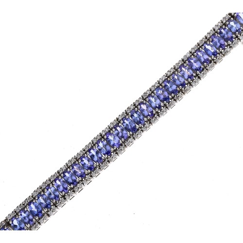 29 - Iliana 18ct white gold tanzanite and diamond bracelet, with a centre band of oval tanzanite within r... 