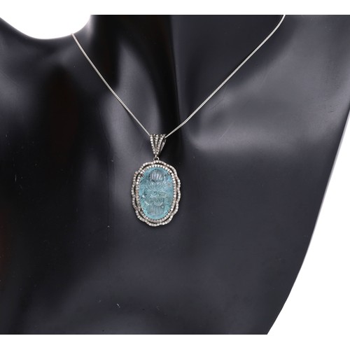 51 - Attractive silver pendant on a slender chain, set with an oval carved aquamarine in a diamond border... 