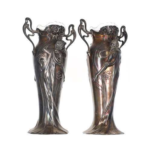 Fine pair of WMF Art Nouveau silver plated figural vases, each worked in relief to either side with stylised flowers and a woman in a swirling robe, twin pierced handles and glass liners, impressed factory marks to base, 14.25" high