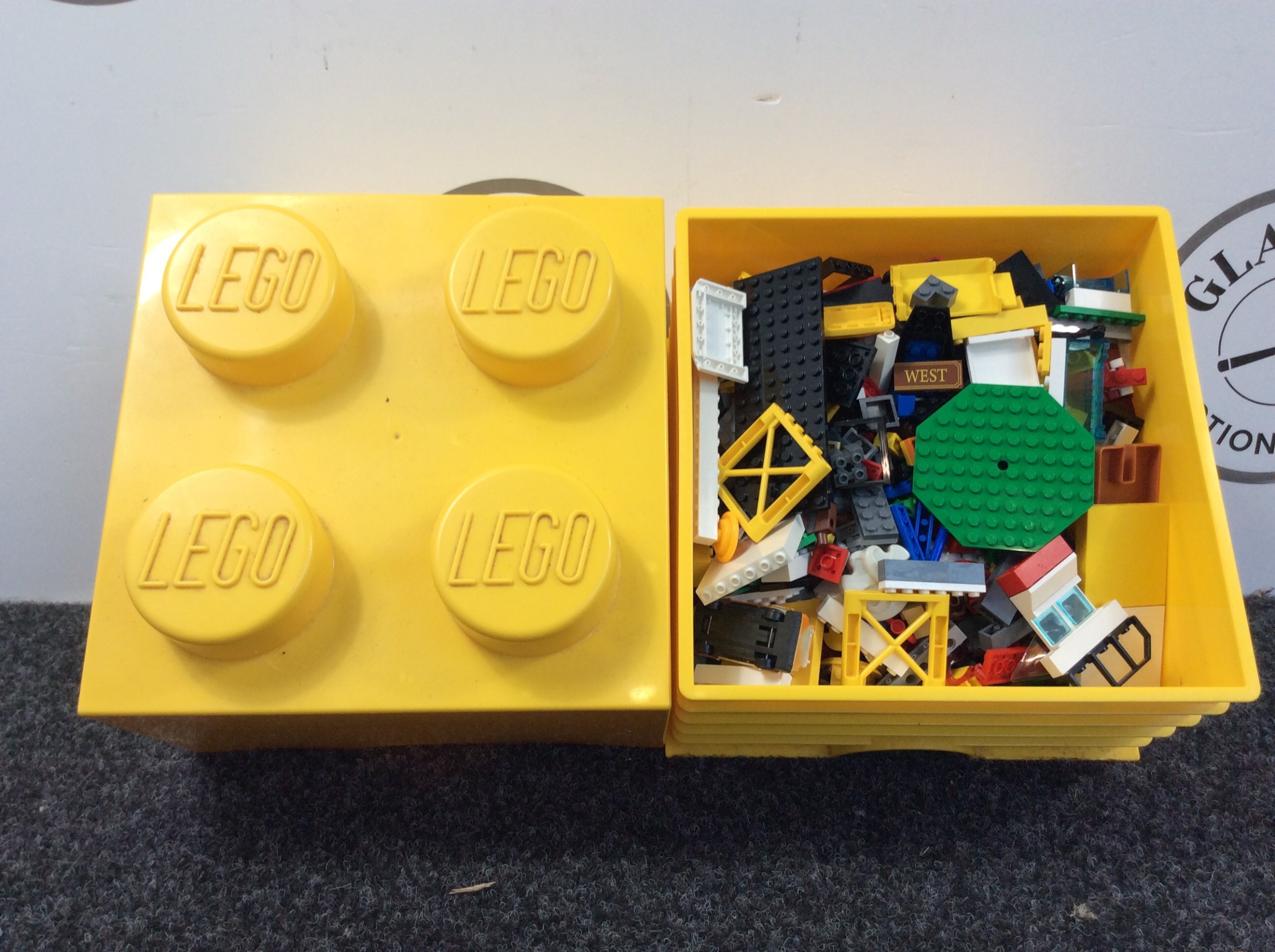 Small yellow Lego box with Lego inside