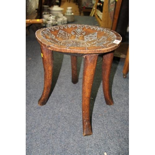 2007 - African: an East African four leg stool, with stylised bead inlaid, 35.5cm diameter.