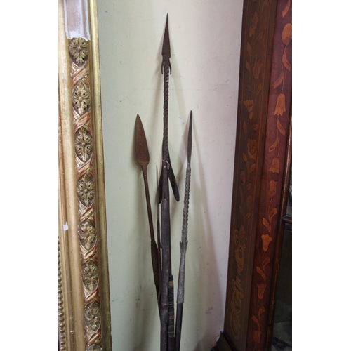 2022 - African: five old spears with shaped heads, some with barbs and wide metal strips wrapped to ends, v... 