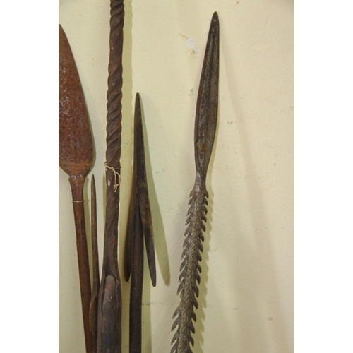 2022 - African: five old spears with shaped heads, some with barbs and wide metal strips wrapped to ends, v... 