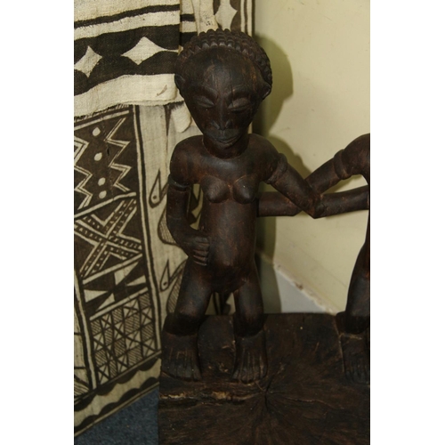 2028 - African: a Chokwe chair, with twin figure back and front supports.