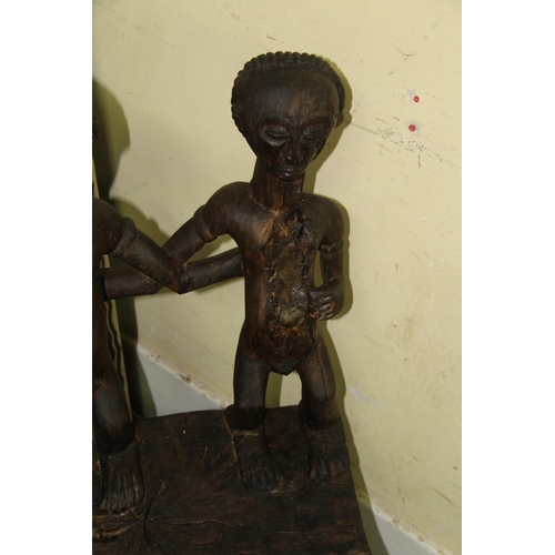 2028 - African: a Chokwe chair, with twin figure back and front supports.