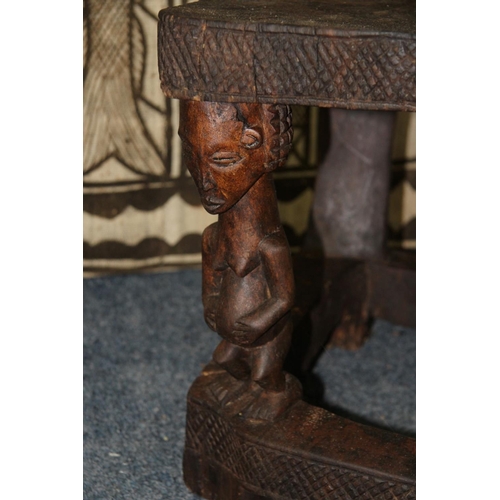 2028 - African: a Chokwe chair, with twin figure back and front supports.