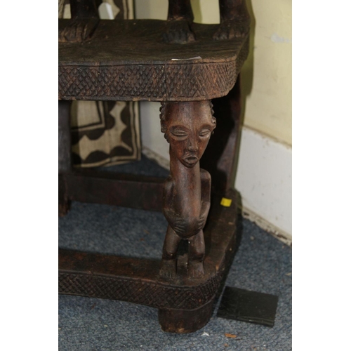 2028 - African: a Chokwe chair, with twin figure back and front supports.