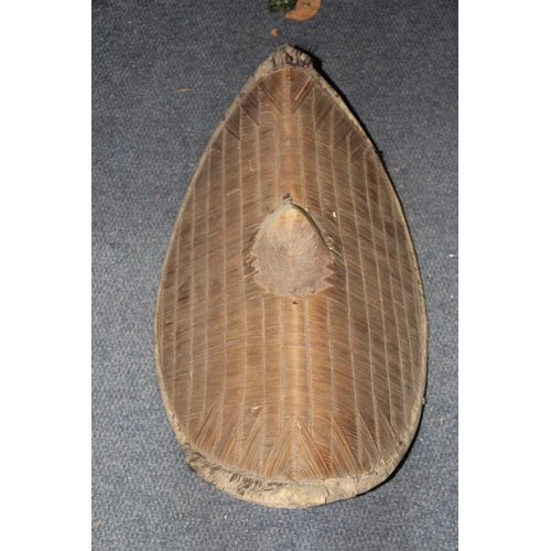 2029 - African: a Ugandan shield of eliptical canted form with central boss and canework, 63.5cm, (a.f)