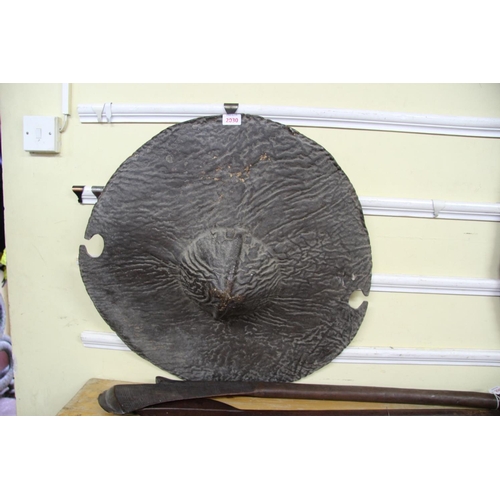 2030 - African: a Sudan circular hide shield, having a central boss and cut outs to the rim, approx 66cm di... 