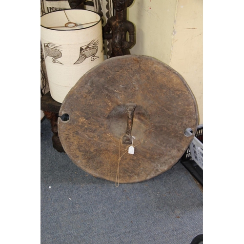 2030 - African: a Sudan circular hide shield, having a central boss and cut outs to the rim, approx 66cm di... 