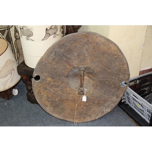 2030 - African: a Sudan circular hide shield, having a central boss and cut outs to the rim, approx 66cm di... 