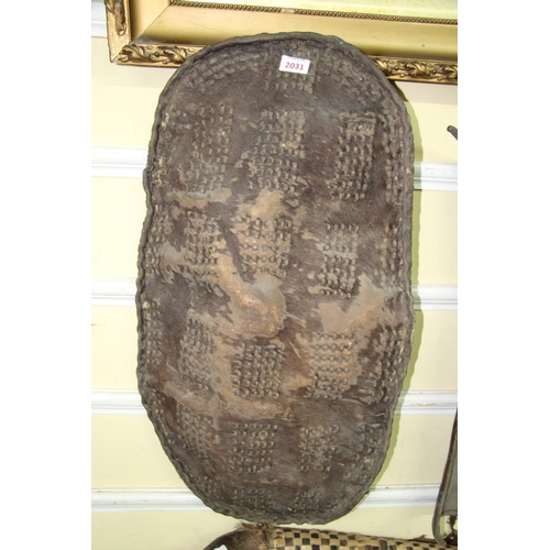 2031 - African: a small hide shield, having rectangular blocks of punched decoration, approx 78.5cm long.