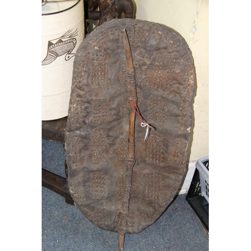 2031 - African: a small hide shield, having rectangular blocks of punched decoration, approx 78.5cm long.