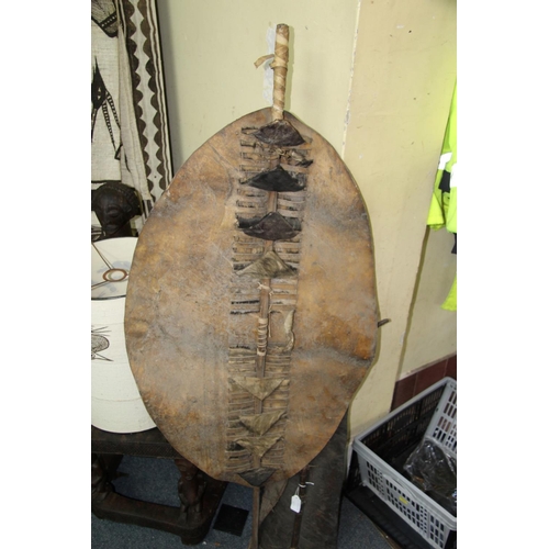 2034 - African: a South African Zulu spotted cowhide shield, with wooden pole, total length 129.5cm.