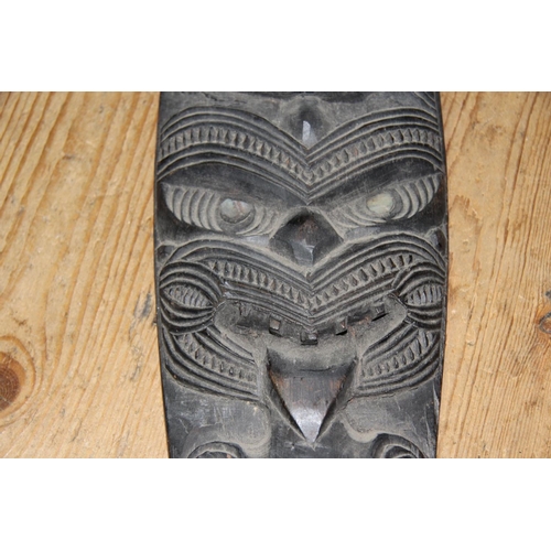 2057 - Oceanic: a 20th century Maori ornamental canoe paddle, carved tiki masks with inlaid shell eyes, app... 