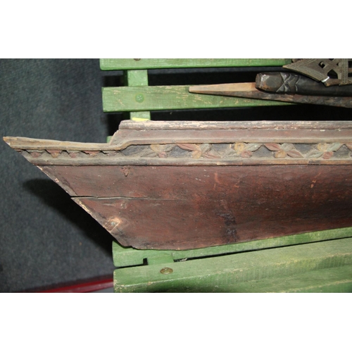 2058 - A ceremonial dug out canoe, with carved freize, 197cm long.